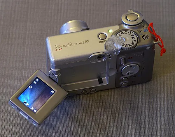 Flip-out LCD - An LCD that flips out like this can be great for odd-angle shots, low shots and macro photography. The duct tape is to keep the dial from moving when I take the camera out of a pocket and the red string is for attaching it to a large retractor I have in my waders.